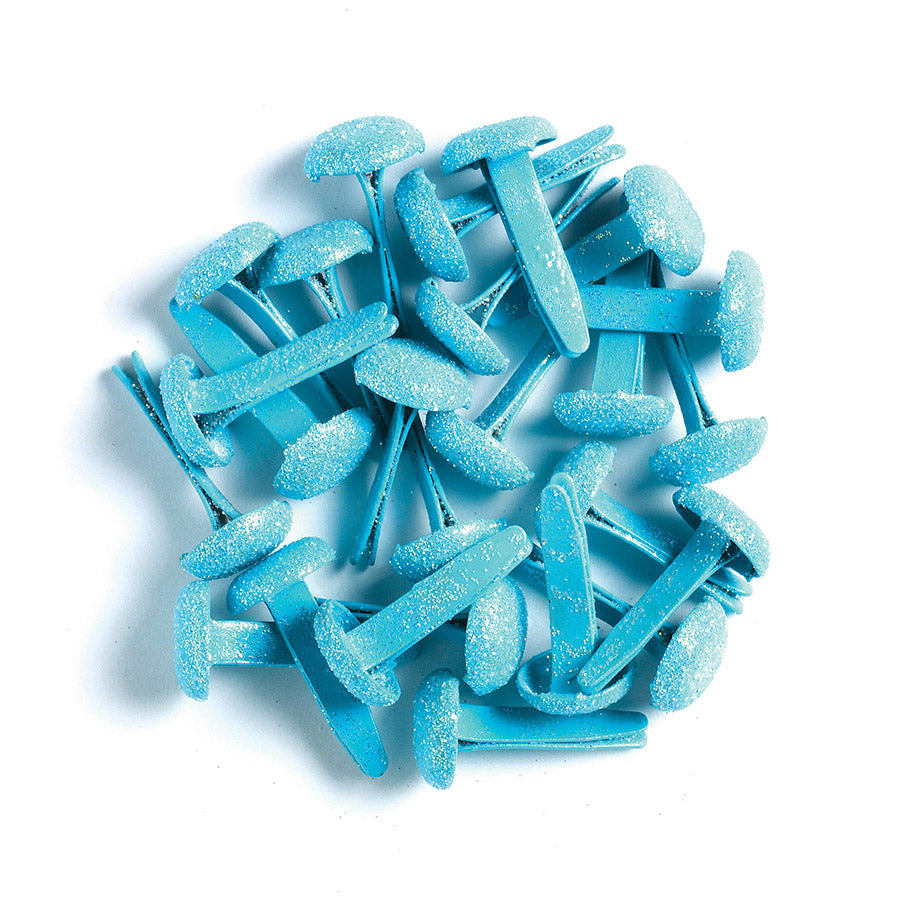 Blue sugar-coated brads on a white background