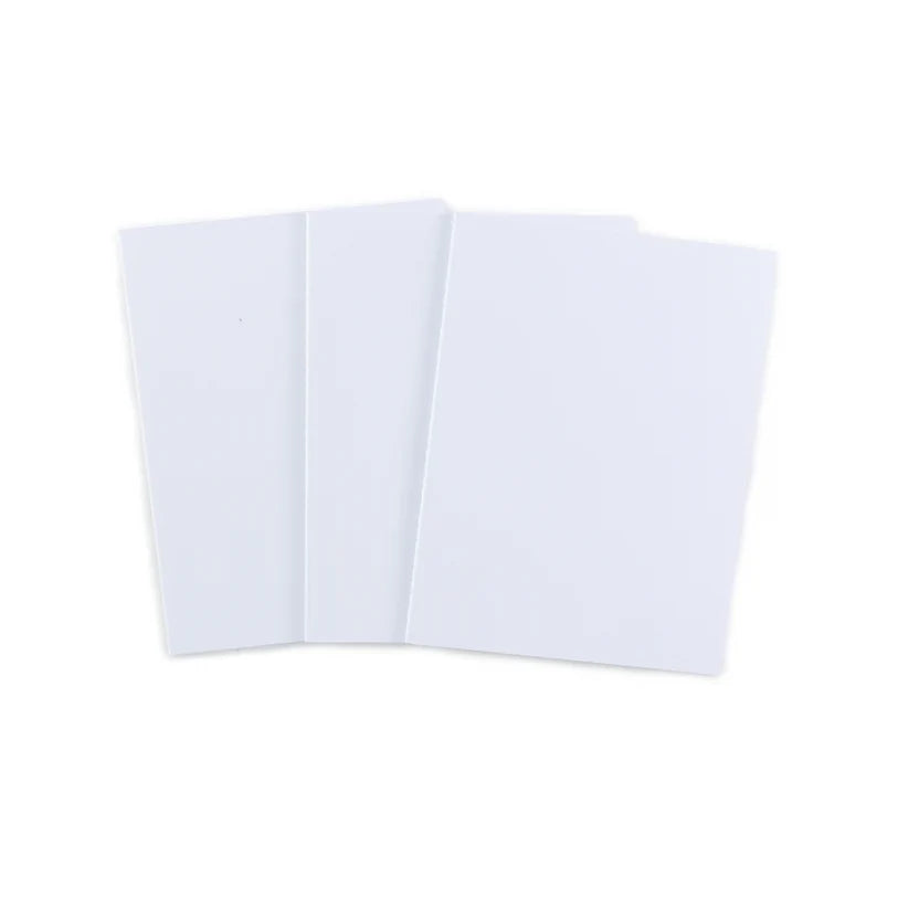 Three blank white rectangular 49 and Market 6 'x 8" journaling notebooks fanned out on a plain white background.