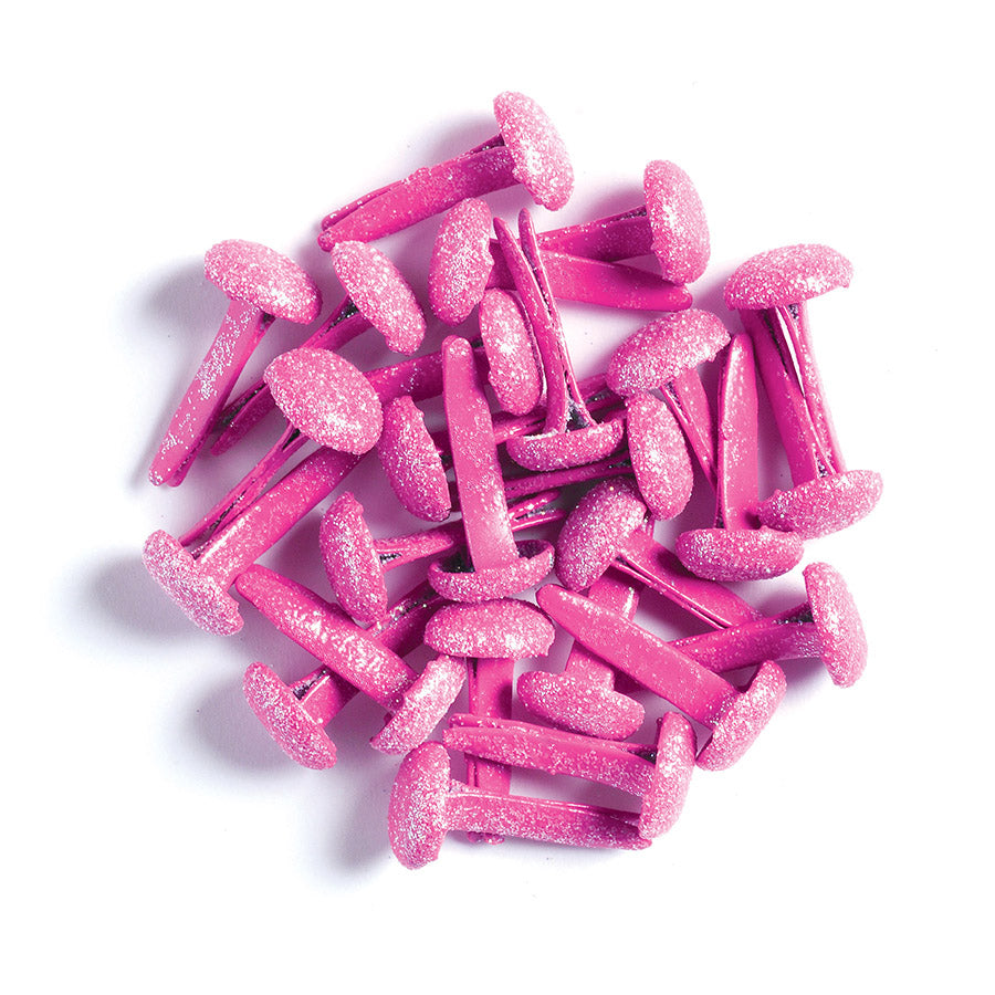 Pink glittery brads on a white background