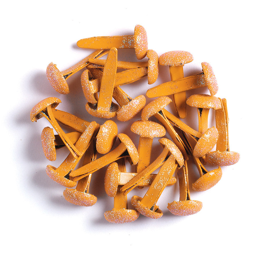 Orange metal paper fasteners with glittery texture on a white background
