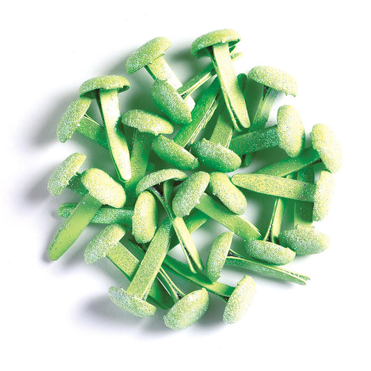 Green sugar-coated paper fasteners (brads) on a white background