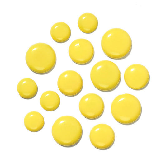 Yellow paper fasteners/brads on a white background