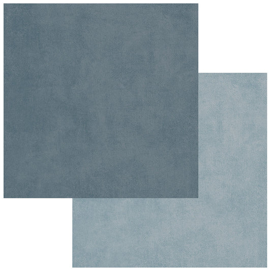Two square fabric or material swatches in muted blue-gray tones, with one darker swatch partially covering a lighter swatch on a white background.