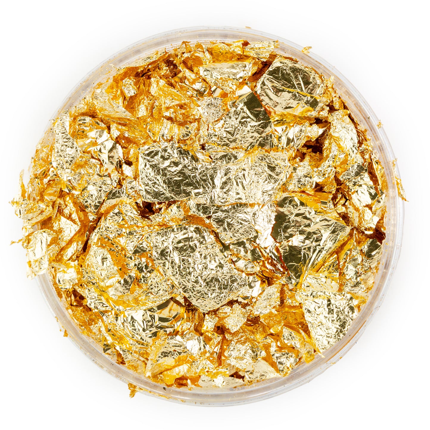 Gold leaf pieces in a container on a white background