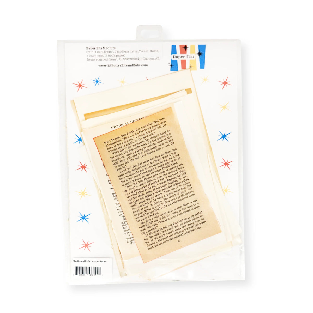 A package of vintage-style book pages and a torn book page insert, shown in a clear plastic sleeve with a white backing card decorated with colorful starburst accents. 