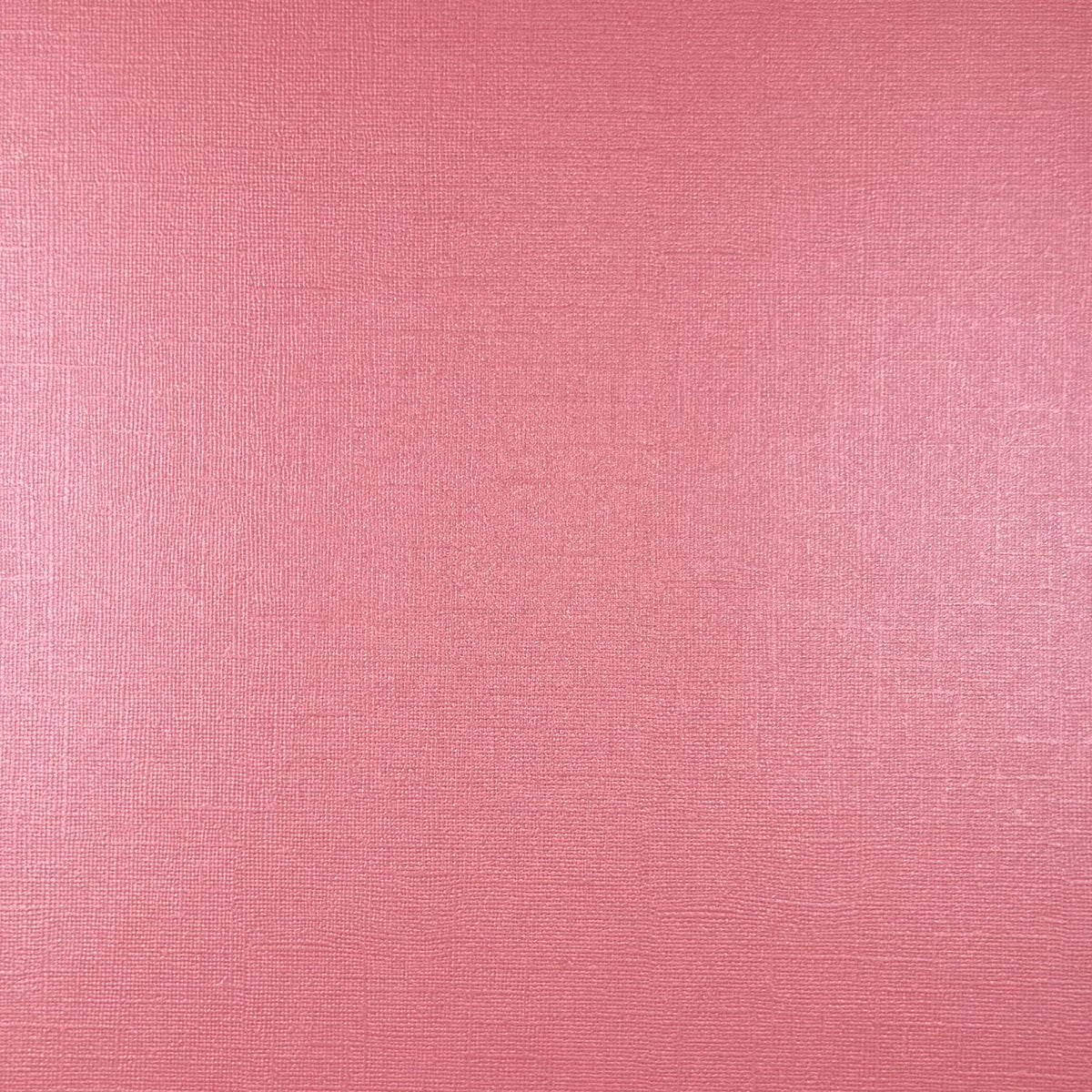 A close-up of a pink textured material with a fine woven or linen-like surface.