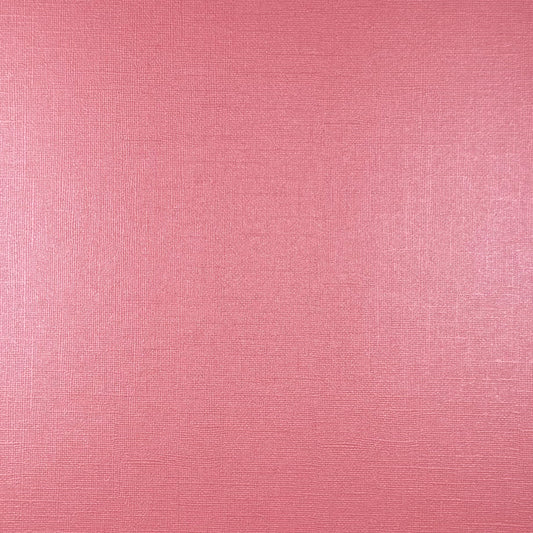 A close-up of a pink textured material with a fine woven or linen-like surface.