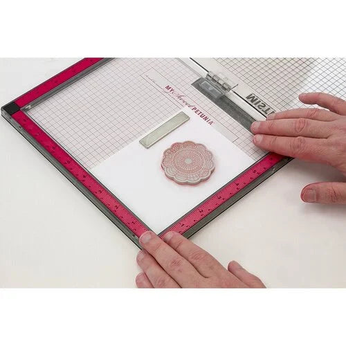 A person's hands are shown using a MISTI platform