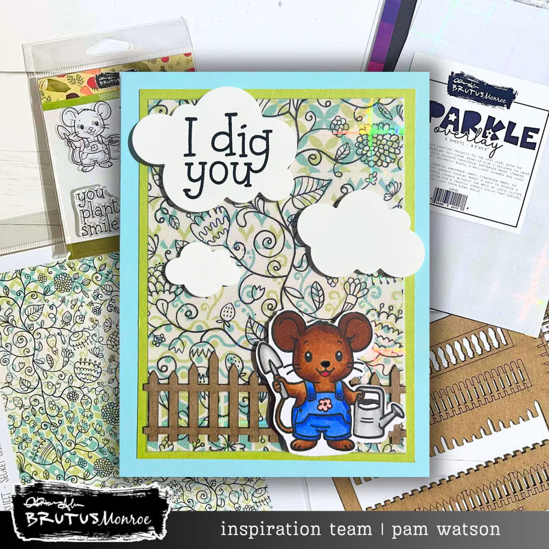 Card with a mouse holding a shovel and watering can, surrounded by stationery items.